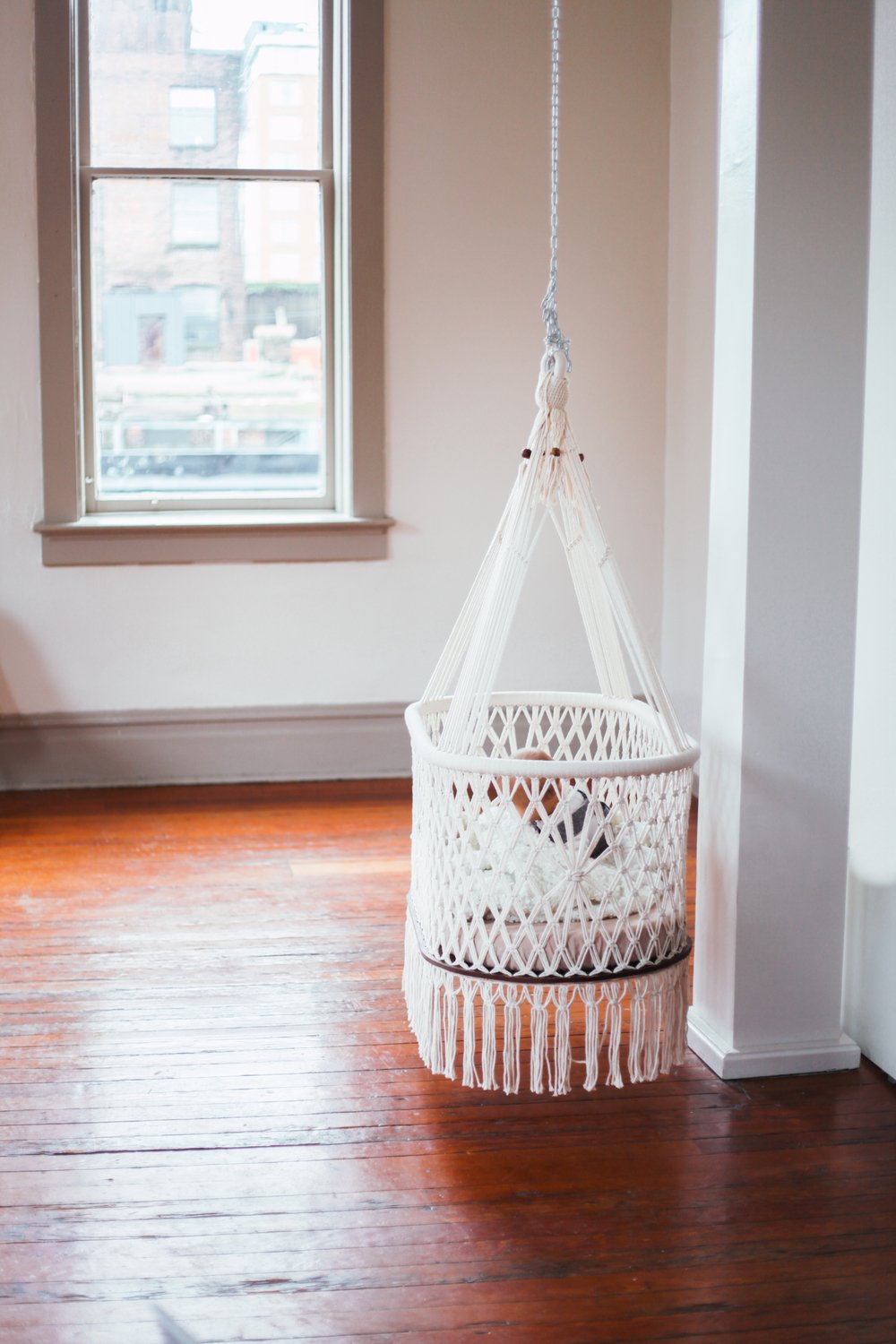 cradle in a room with wood floor