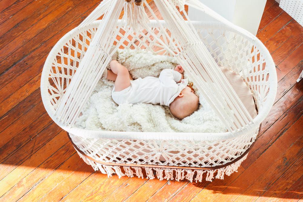 baby on a mattress in a cradle - top view