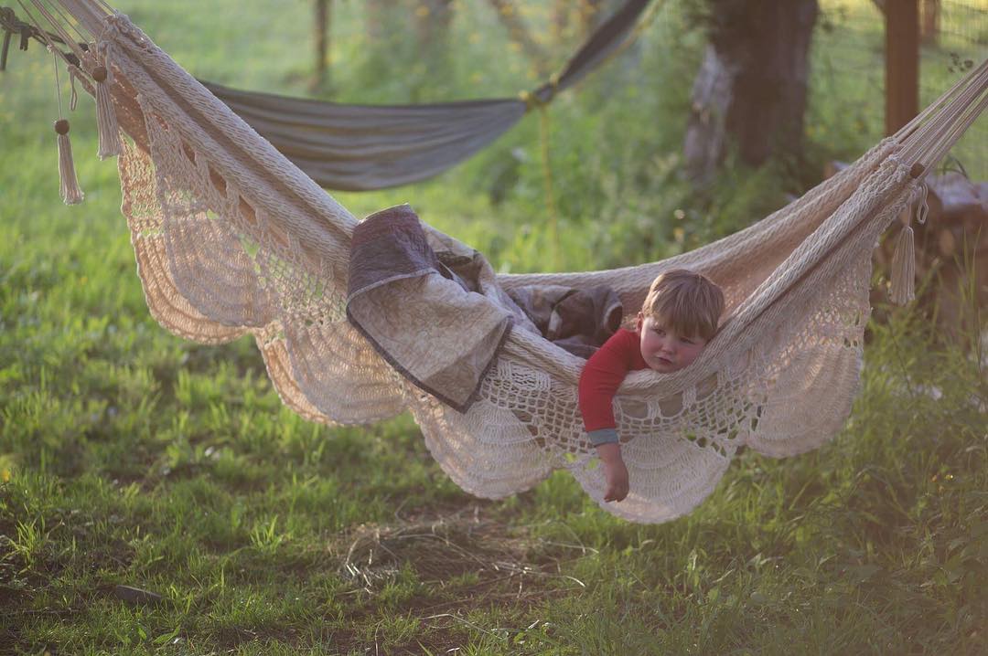 baby relaxing on a hammock in the backyard