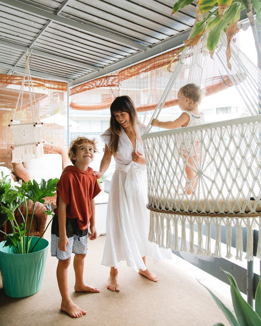 family, motherhood and a cradle - swing chair on the back