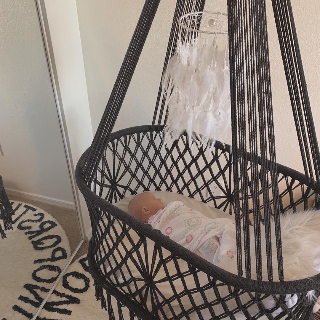 baby sleeping in a black color cotton bassinet