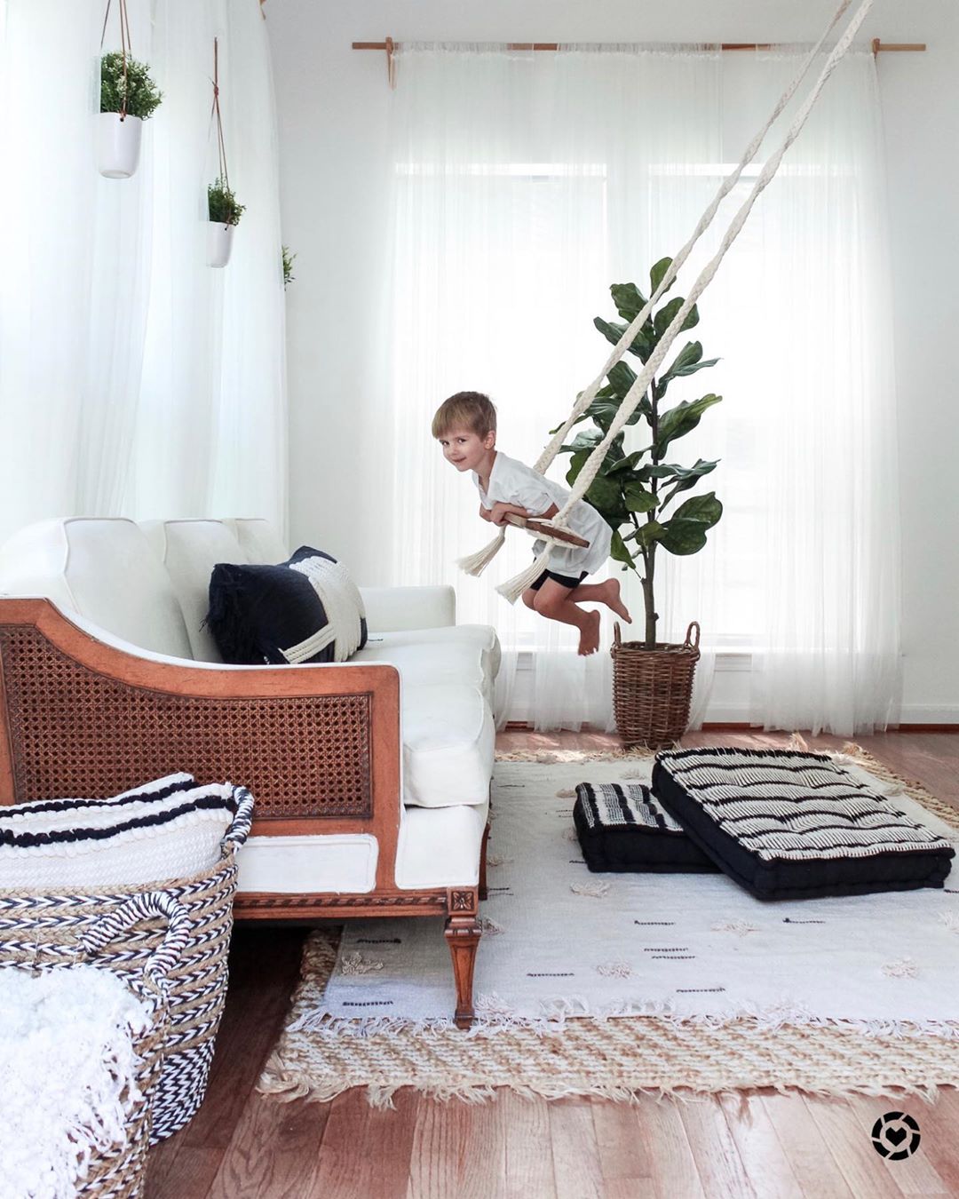 kind playing on a tree swing indoor
