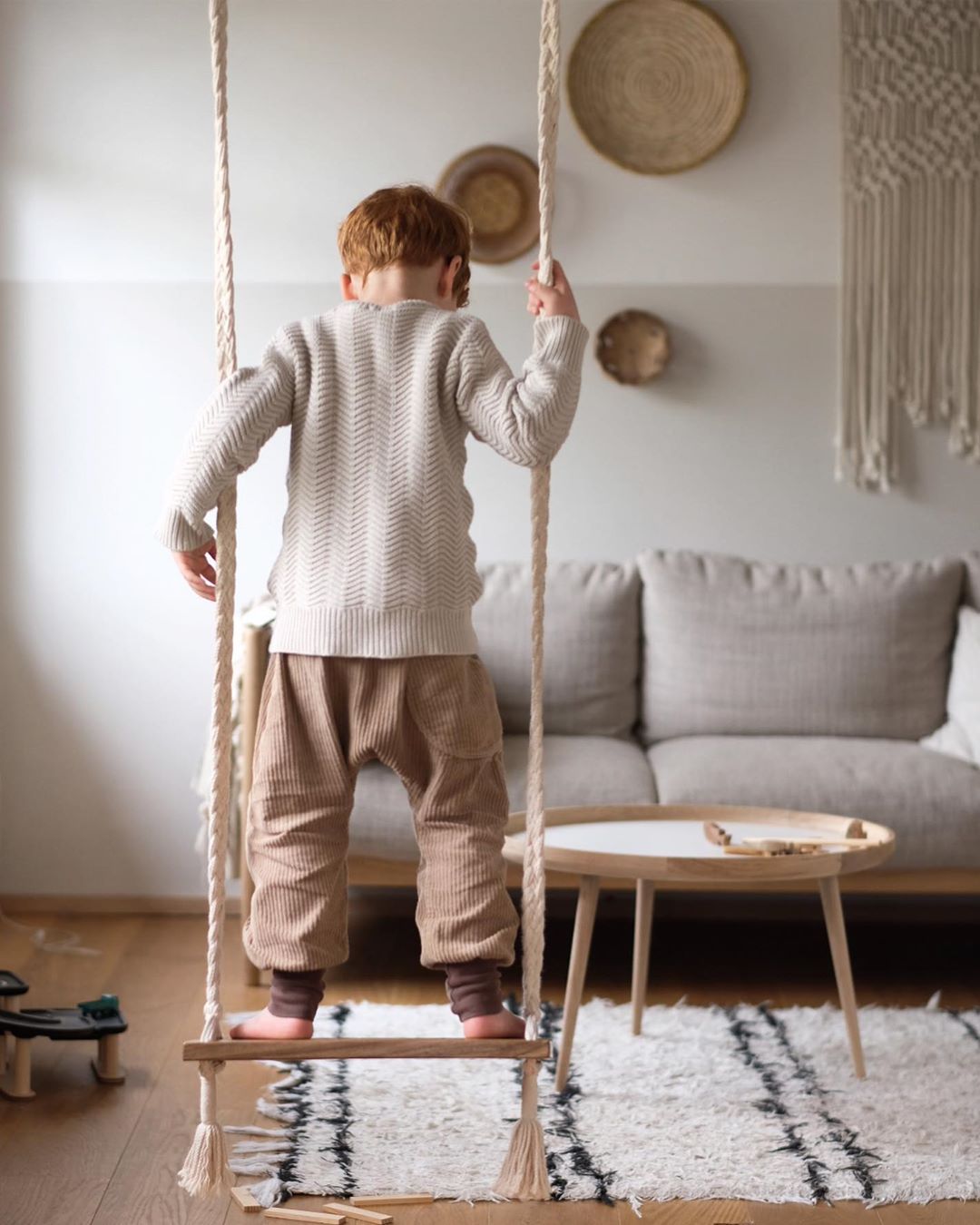 kid stand up on a Swing chair