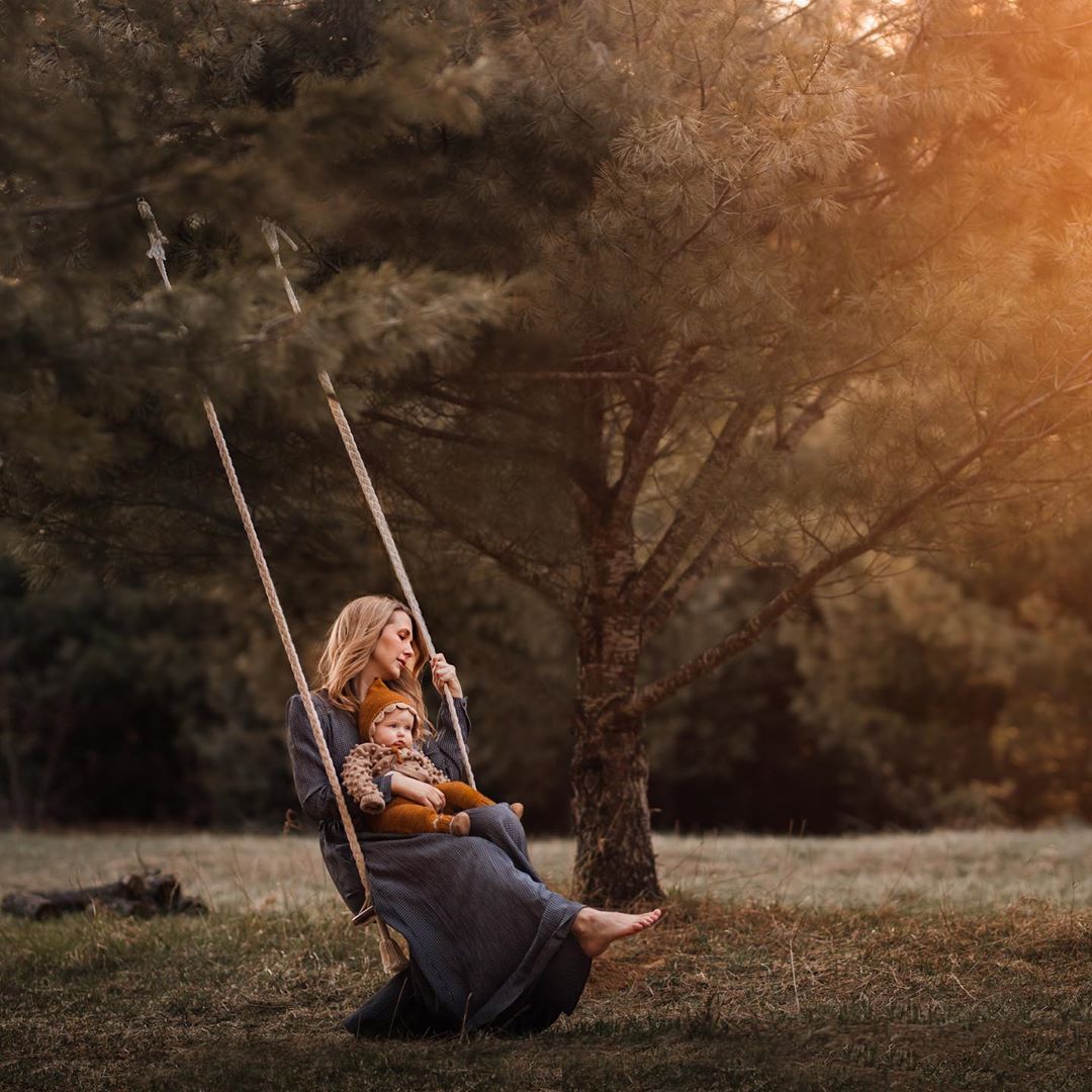 tree swing in the wood with mother and baby