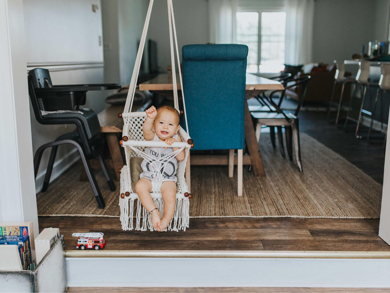 baby swing chair in cream - style picture with baby at home - front view