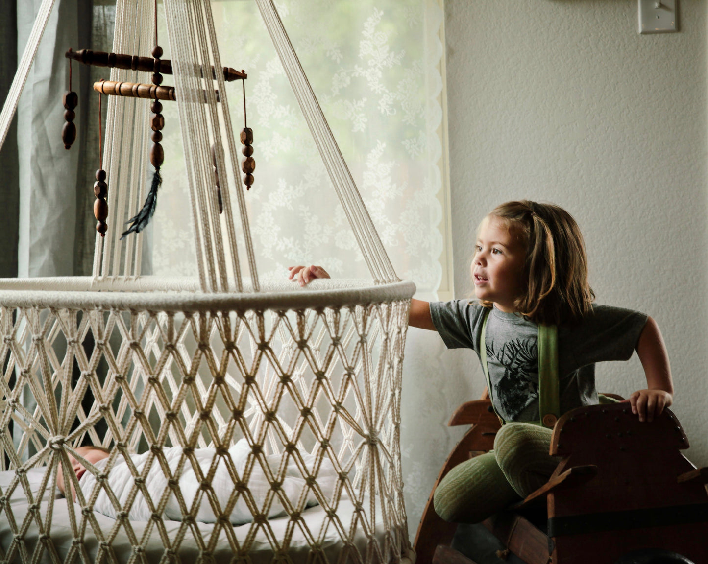 kid rocking a cradle