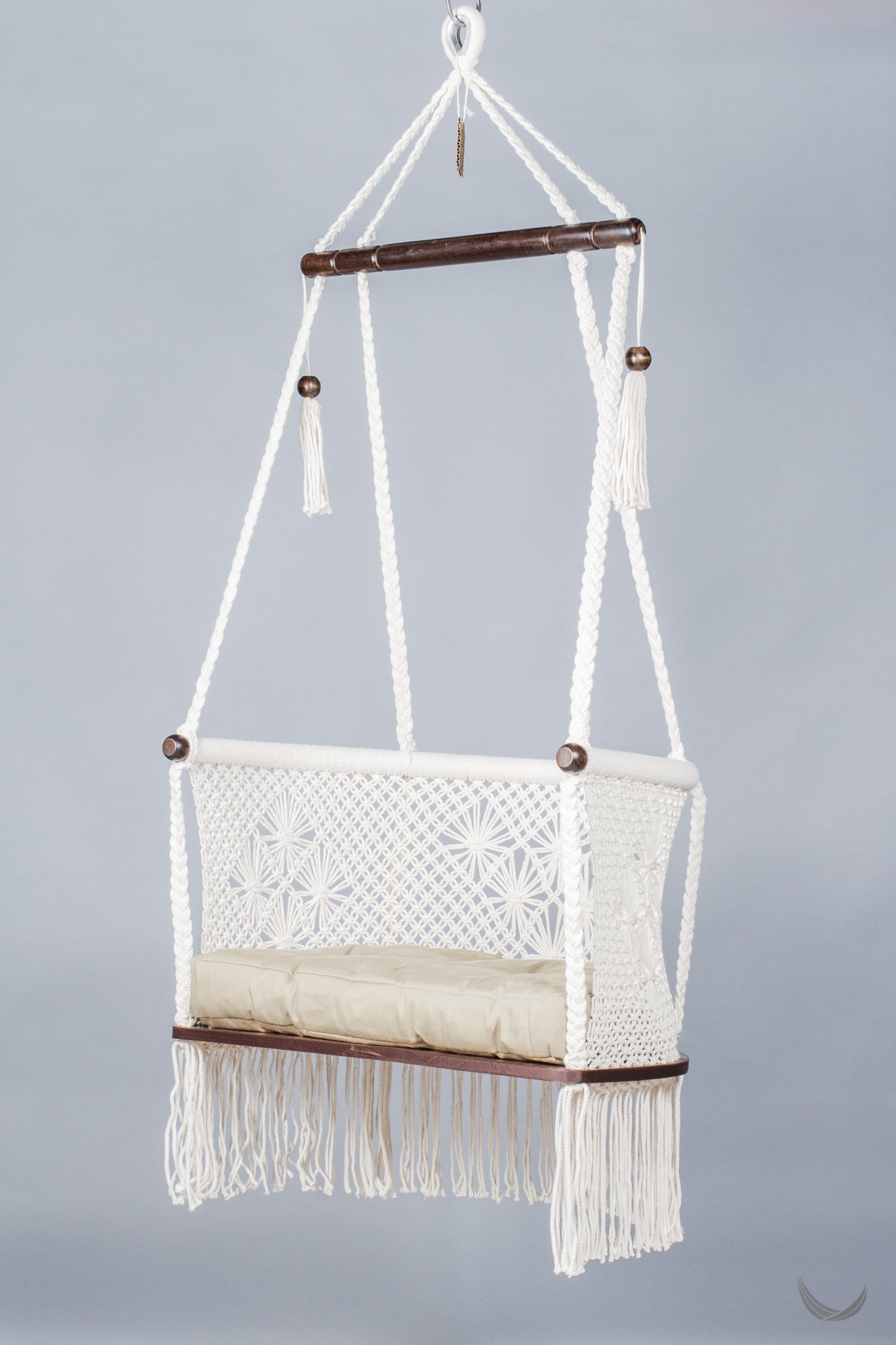 ivory color hanging chair with a khaki color cushion