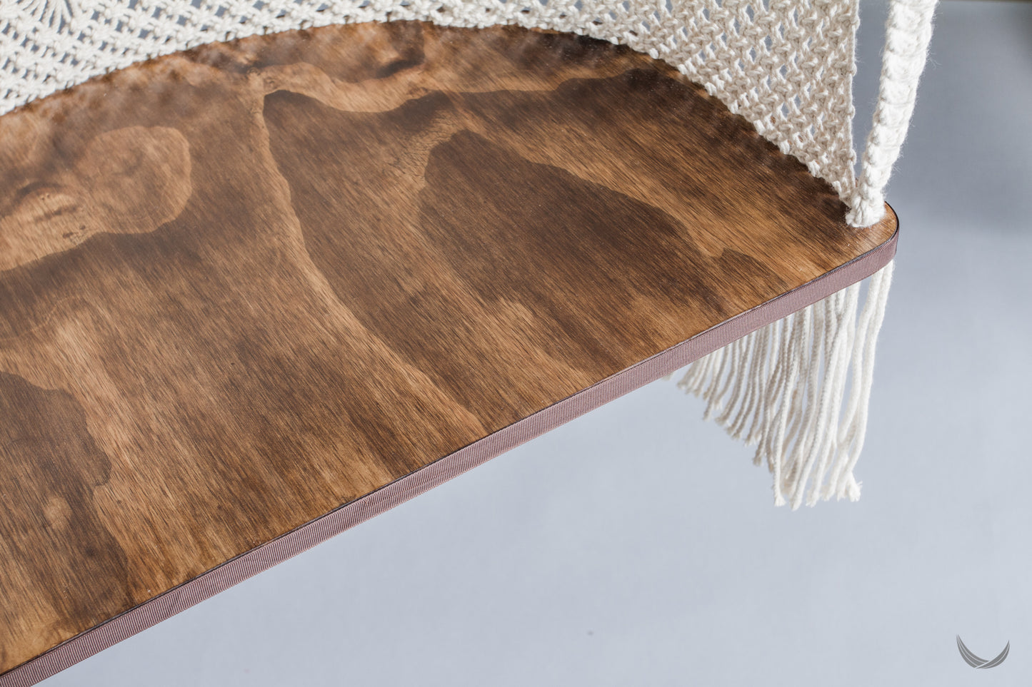 plywood half-moon seat of a hanging chair