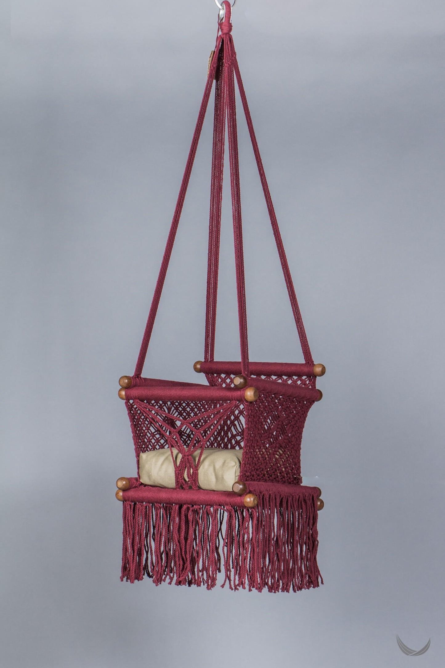 macrame swing in bordeaux with beige cushion