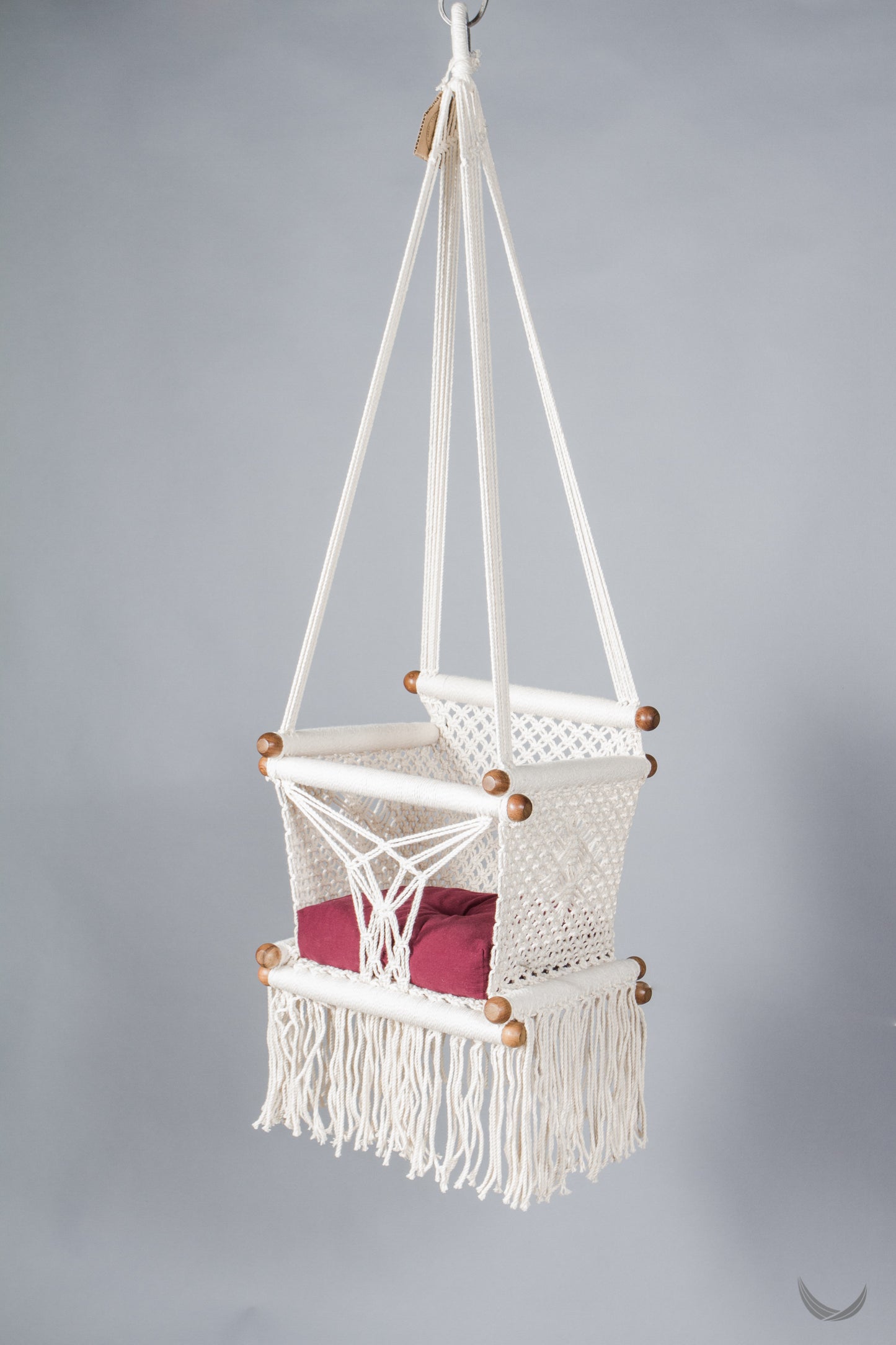 ivory color baby swing chair with a red color pad