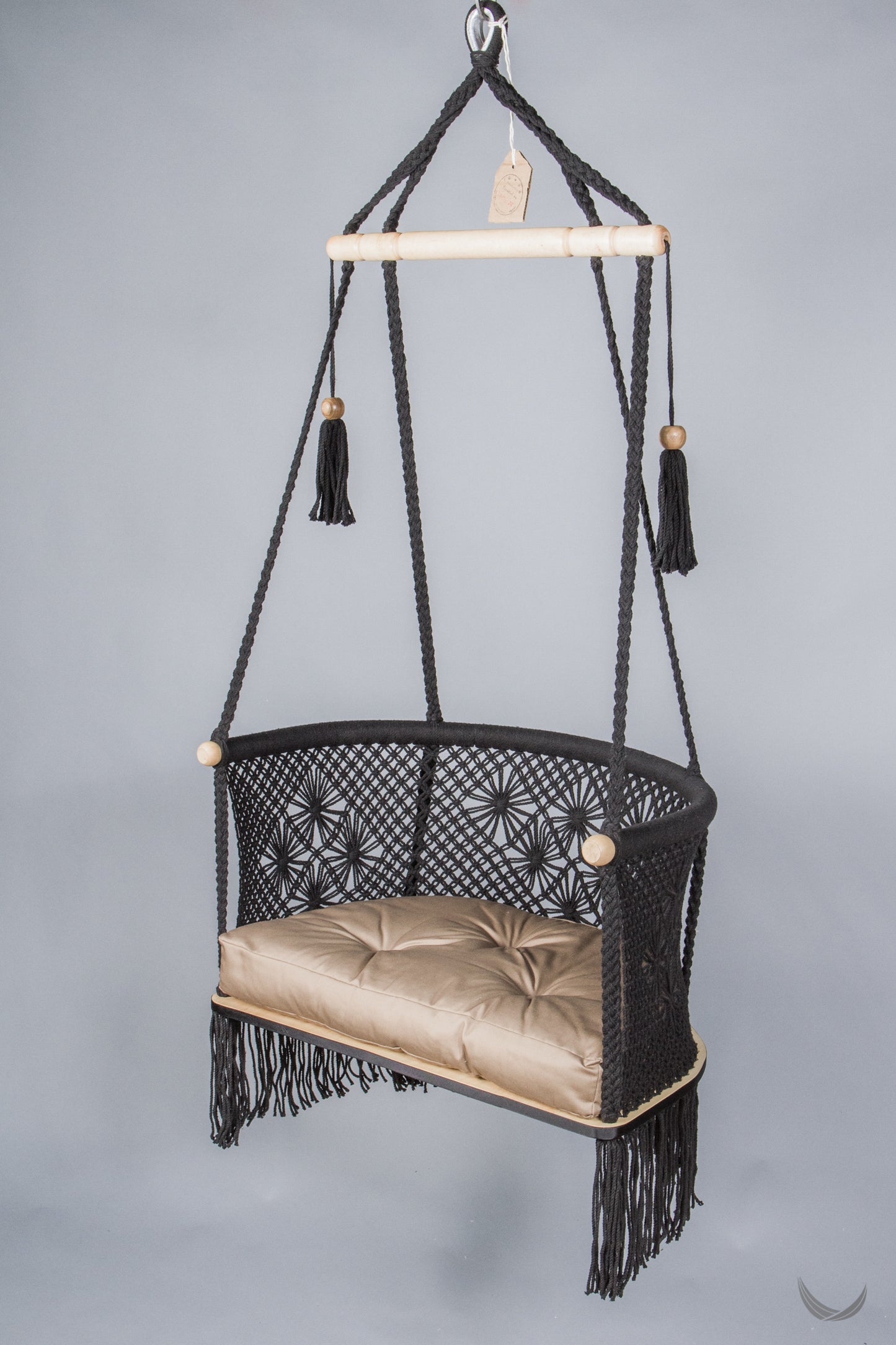 black color hanging chair with a khaki color cushion
