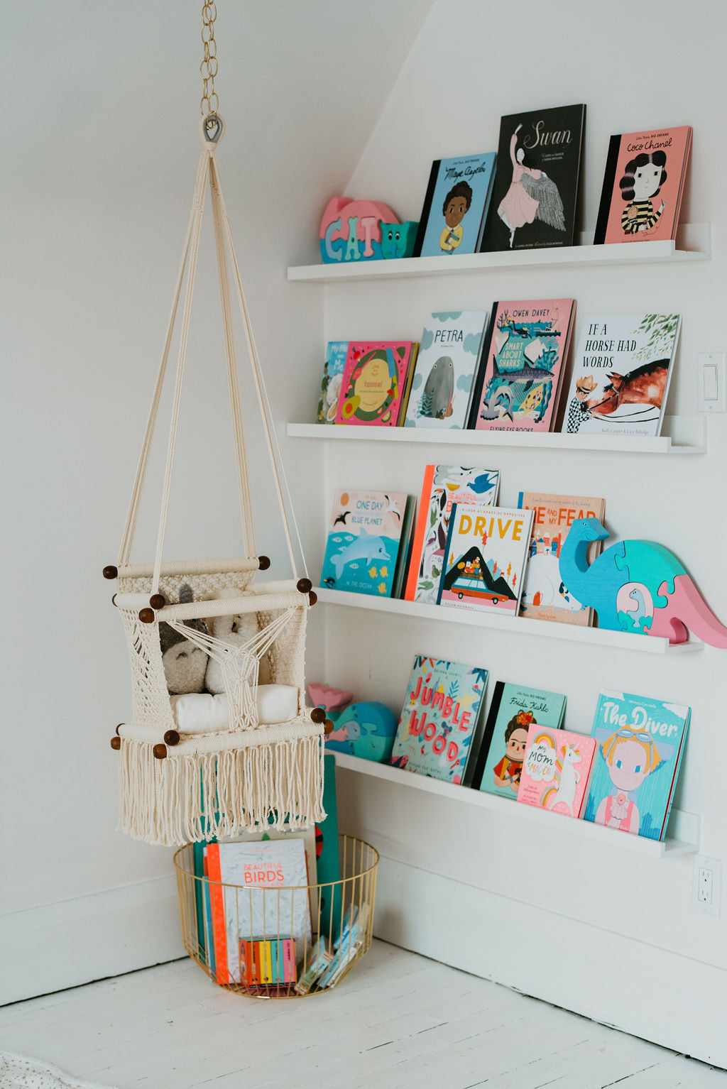 baby swing chair in macrame with a bookstore in the background