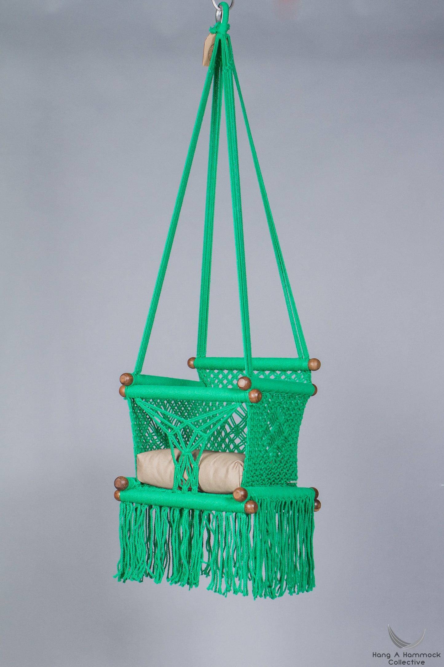 swing chair in green - khaki cushion - studio picture