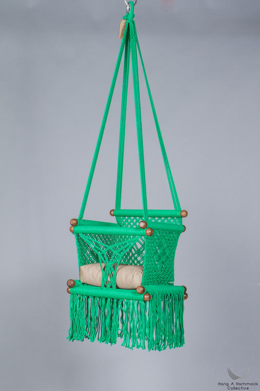 swing chair in green - khaki cushion - studio picture