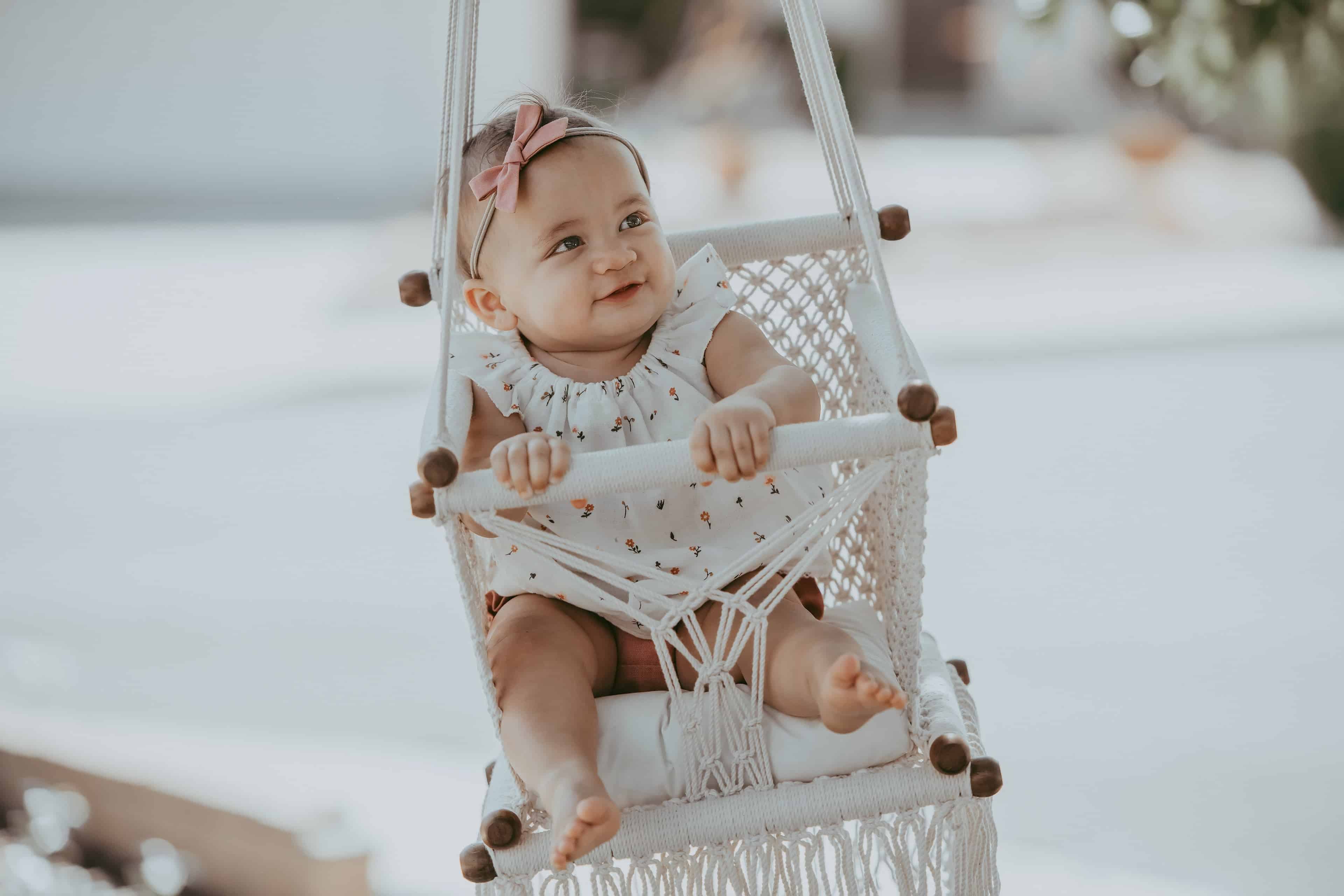 baby on a macrame swing chair