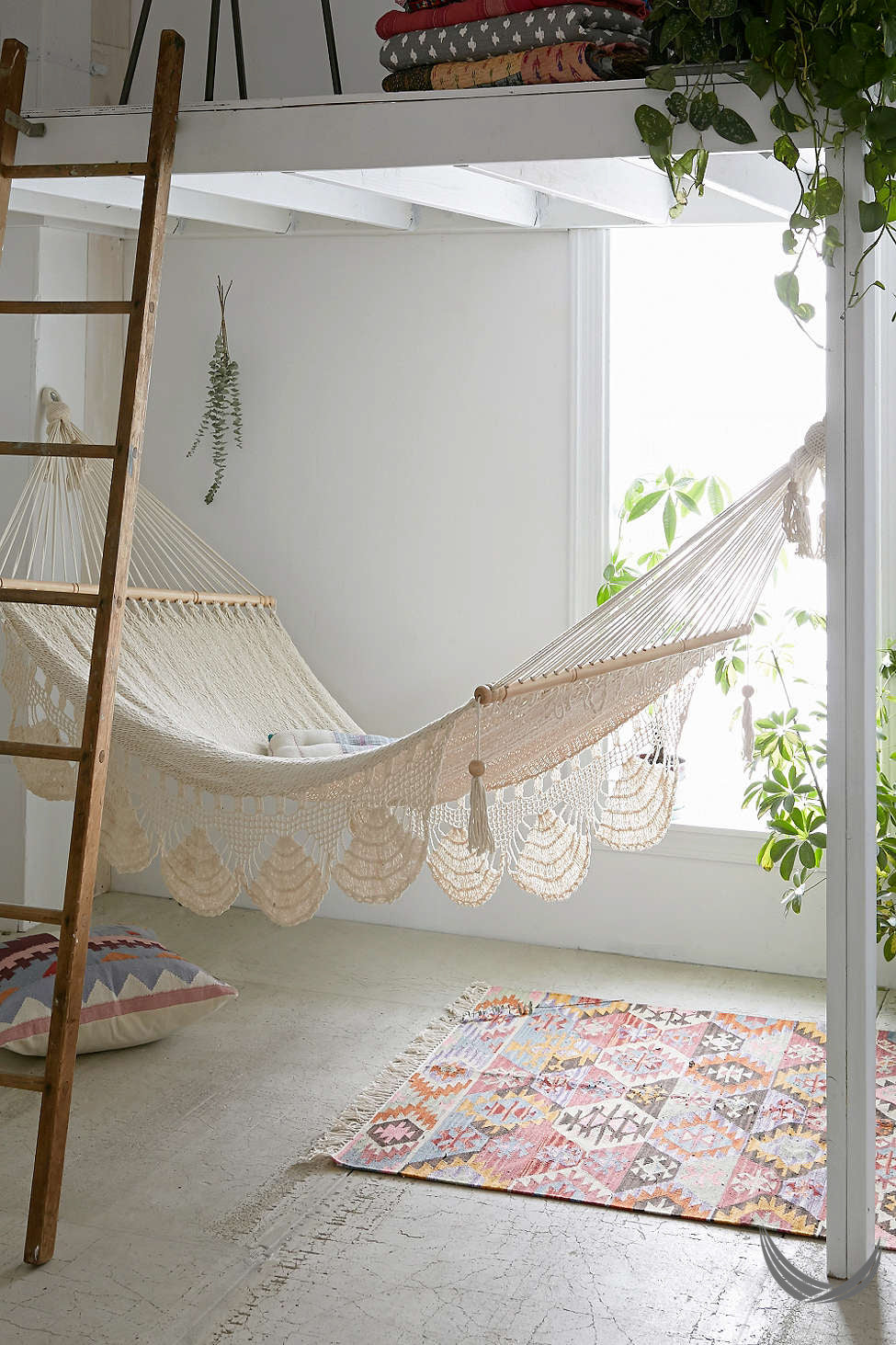 indoor handwoven hammock under a mezzanine
