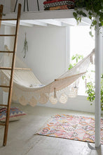 indoor handwoven hammock under a mezzanine