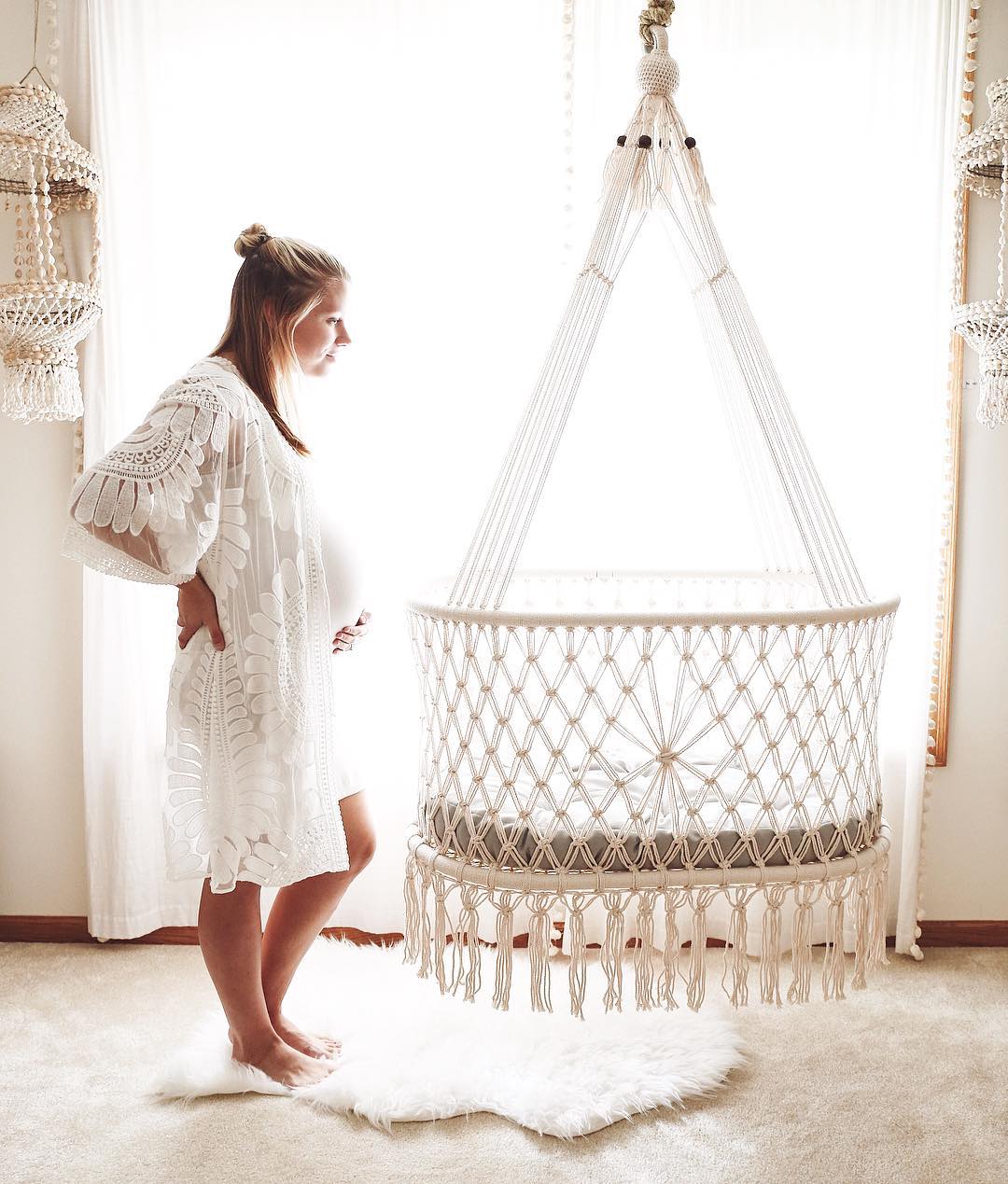 pregnant mother near by a hanging bassinet