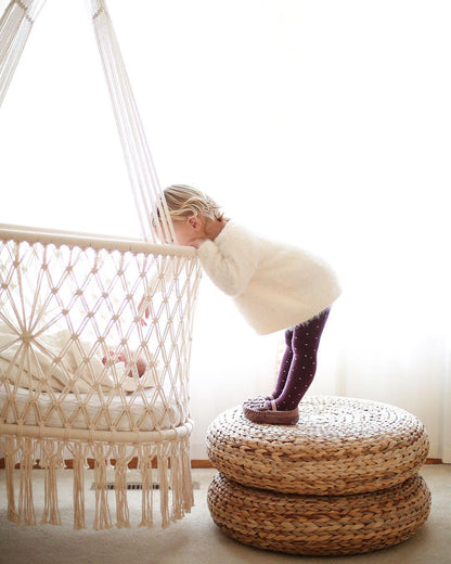 kid near by a hanging bassinet