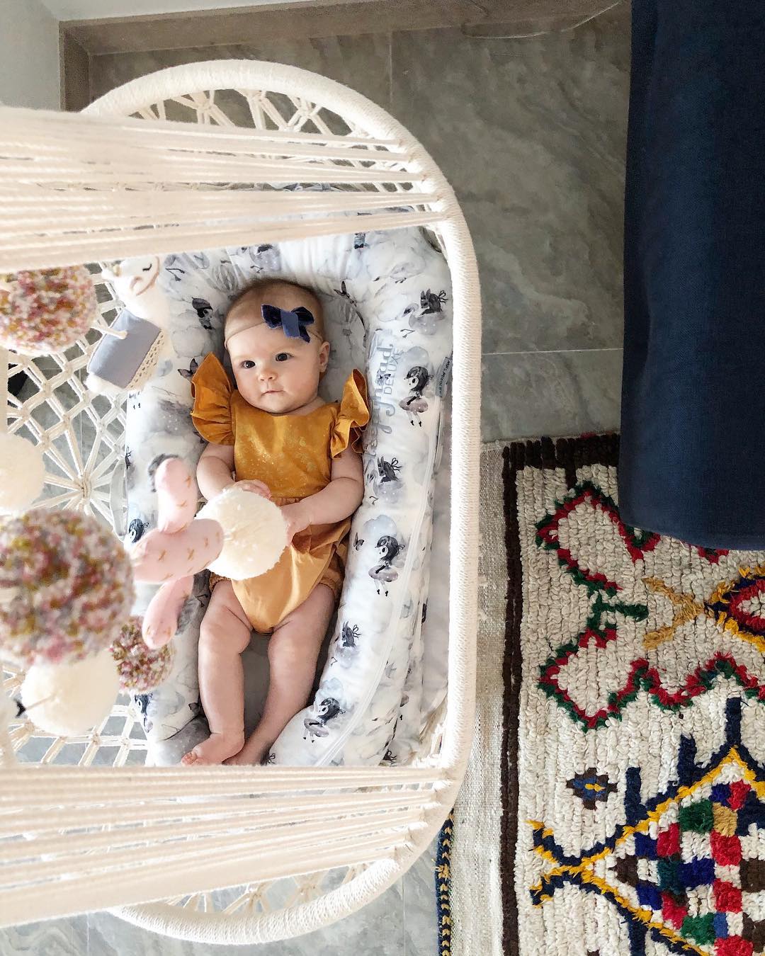 baby smiling in a hanging cradle