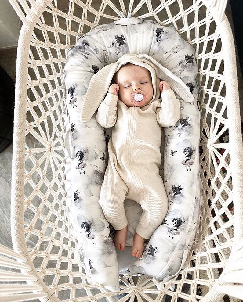 baby on a mattress in a cradle - top view