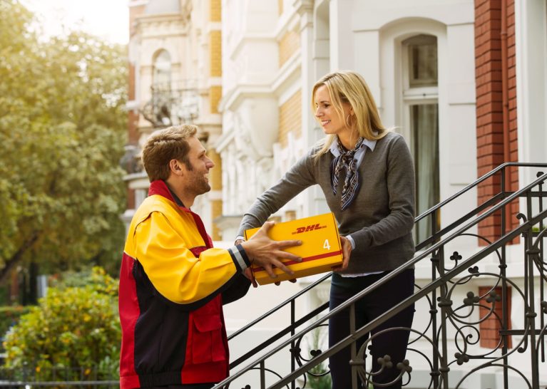 DHL EXPRES courier man delivery a package to a woman