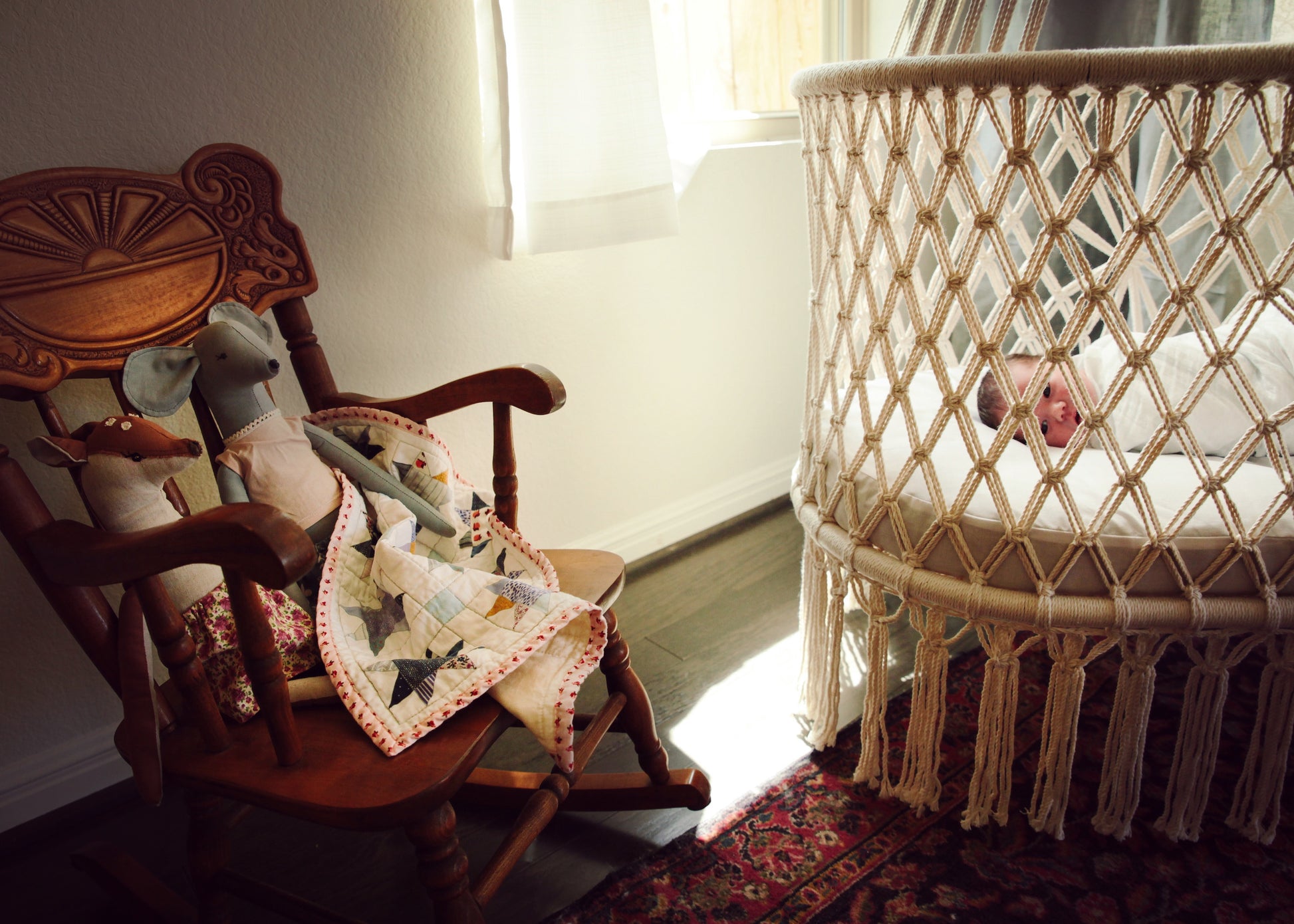 rocking chair near by a hanging crib