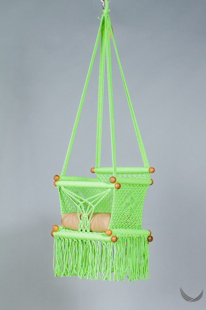 swing chair in macrame - pistachio color - with beige cushion - studio photo