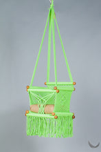 swing chair in macrame - pistachio color - with beige cushion - studio photo