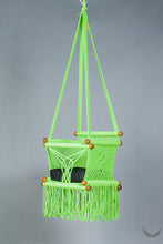 swing chair in macrame - pistachio color - with black cushion - studio photo