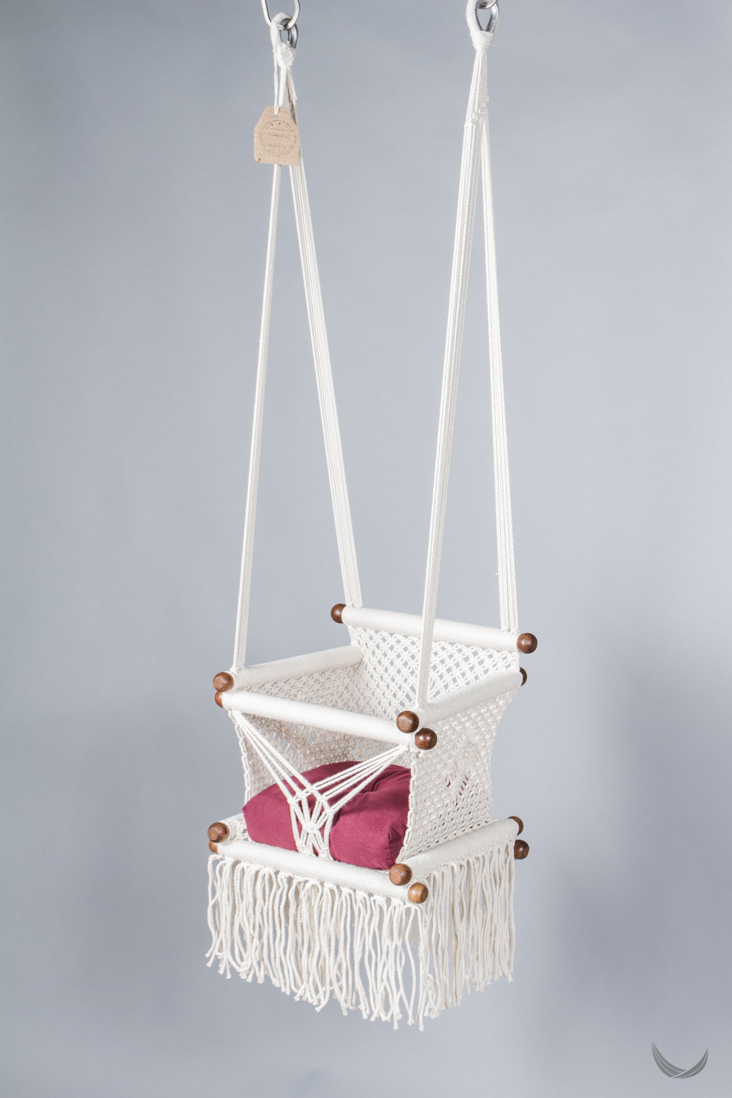 ivory color baby swing chair with a red color pad