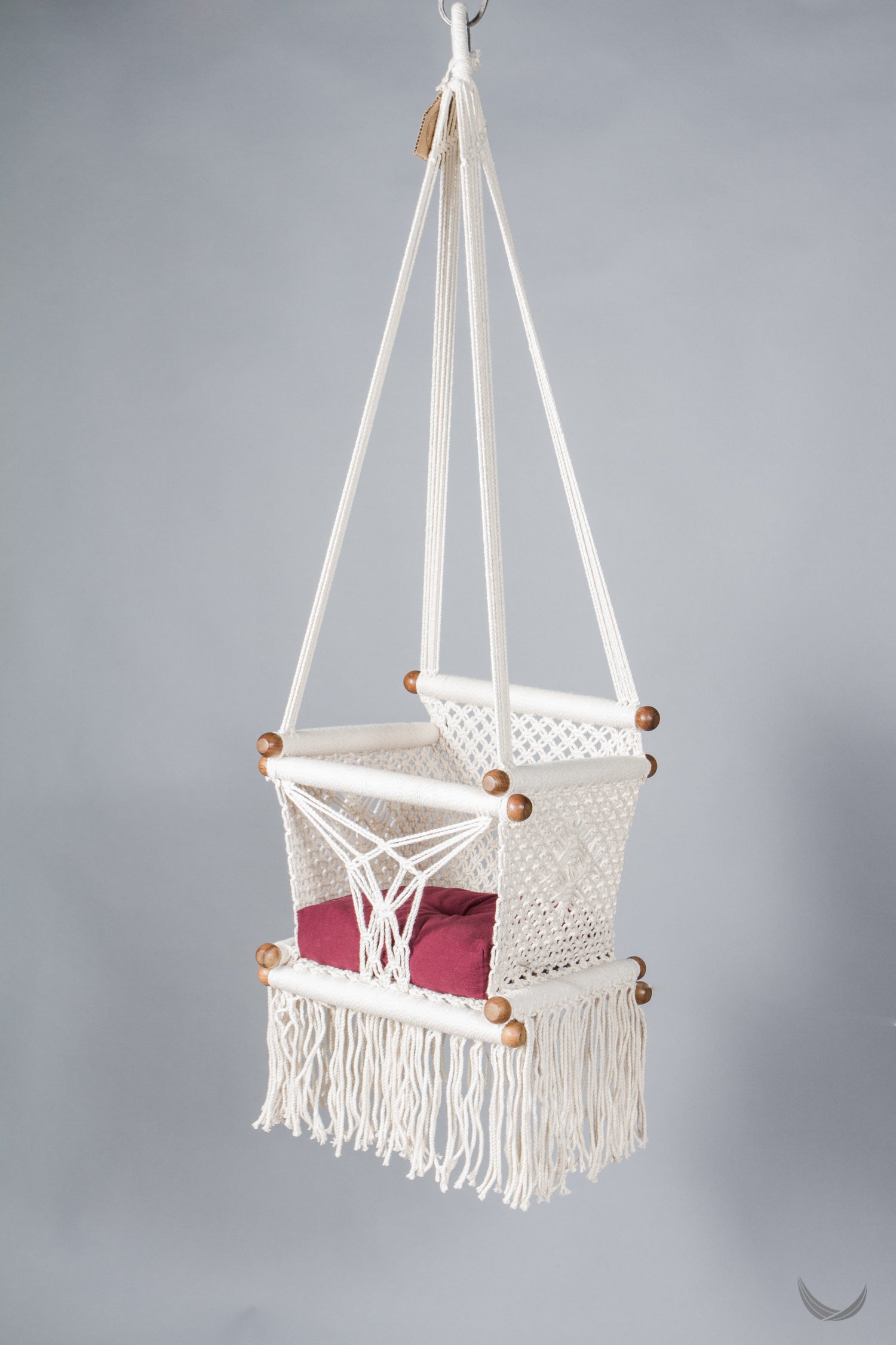 ivory color baby swing chair  with a red color pad