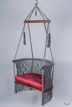 gray color hanging chair with a red color cushion
