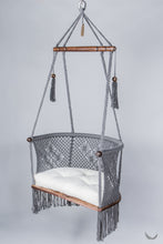 gray color hanging chair with a ivory color cushion