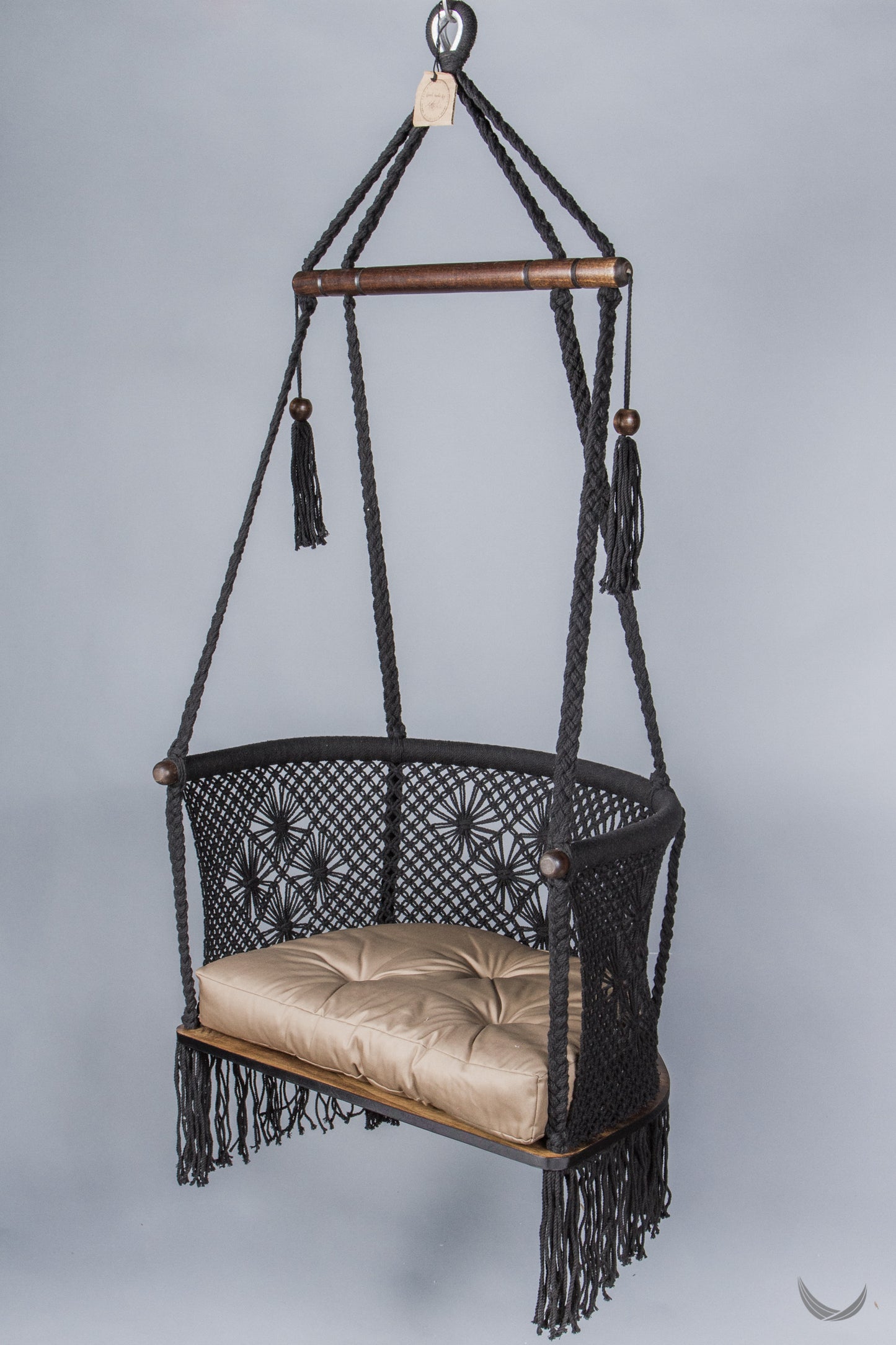 black color hanging chair with a khaki color cushion