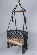 black color hanging chair with a khaki color cushion