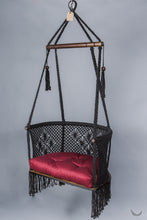 black color hanging chair with a red color cushion