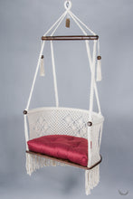 ivory color hanging chair with a red color cushion