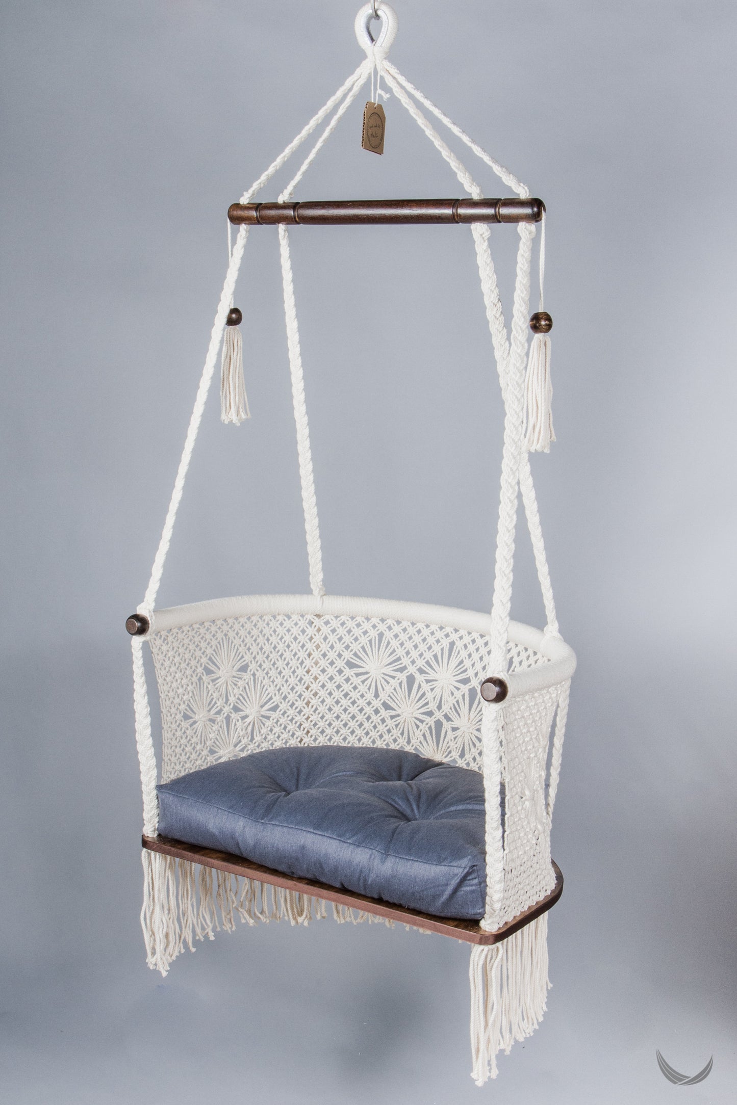 ivory color hanging chair with a blue color cushion