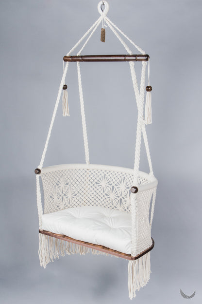 ivory color hanging chair with a ivory color cushion