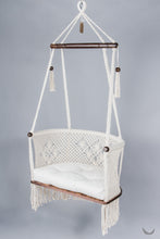 ivory color hanging chair with a ivory color cushion