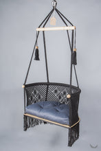 black color hanging chair with a blue color cushion