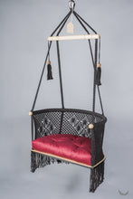 black color hanging chair with a red color cushion