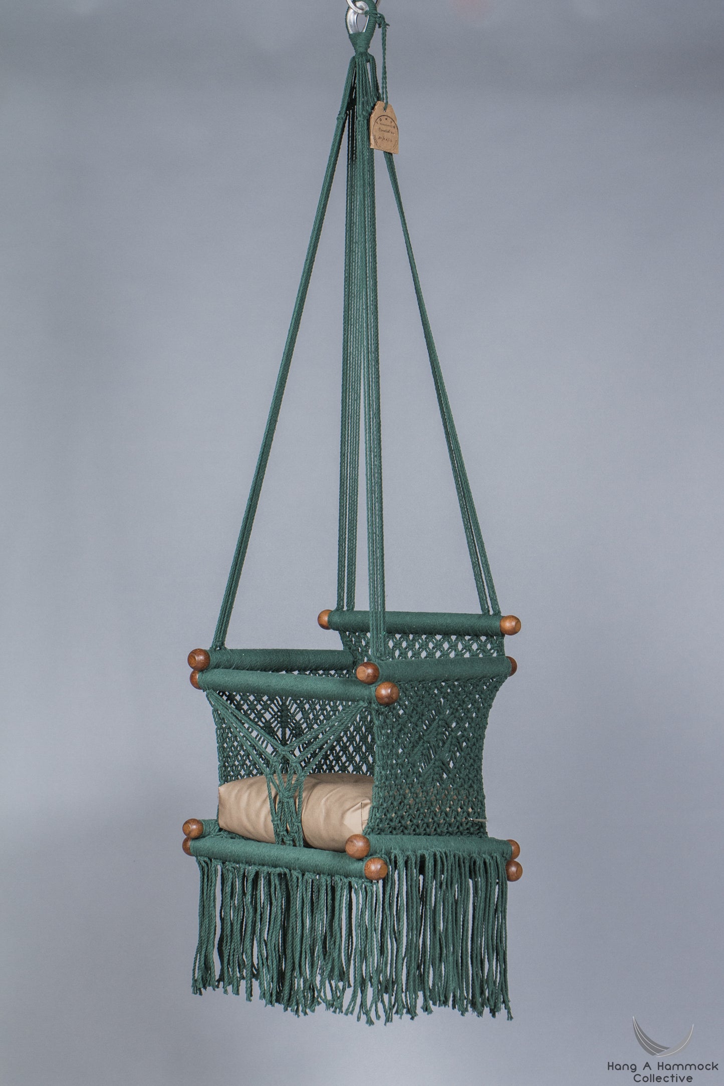 baby swing chair in dark green - khaki cushion - studio picture