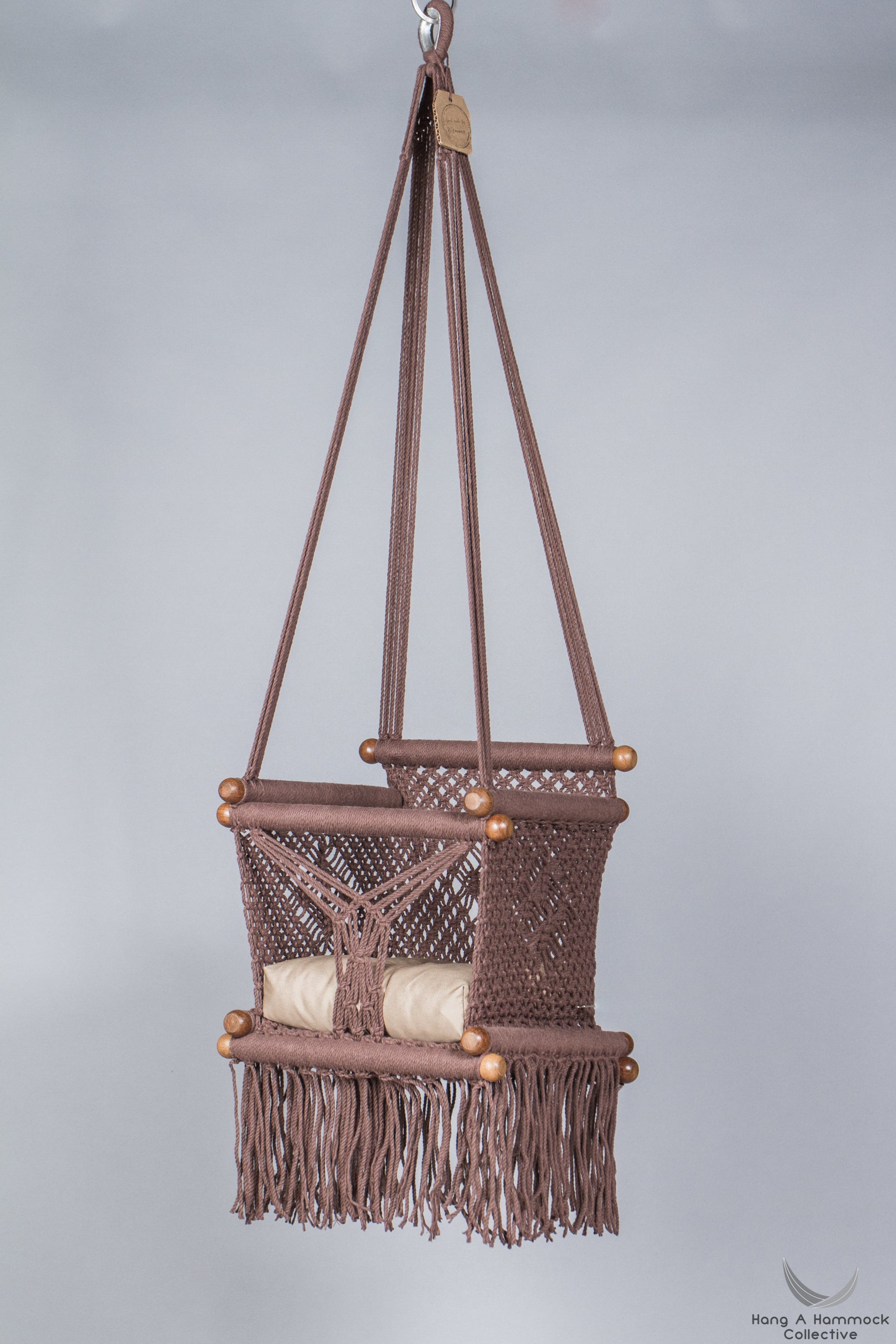 baby swing chair in brown - khaki cushion - studio picture