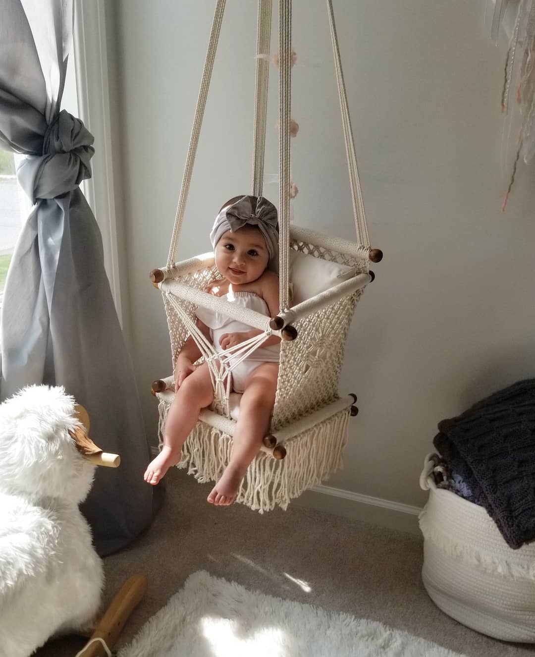 baby on a enclosed swing chair